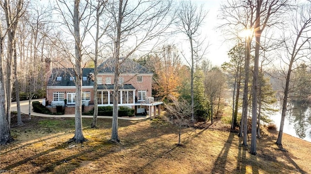 back of house with brick siding and a wooden deck