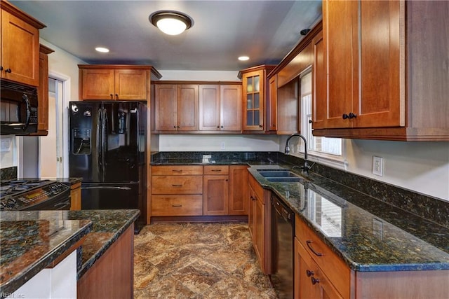 kitchen featuring black appliances, brown cabinets, and a sink