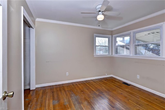 unfurnished bedroom featuring crown molding, hardwood / wood-style flooring, visible vents, and baseboards