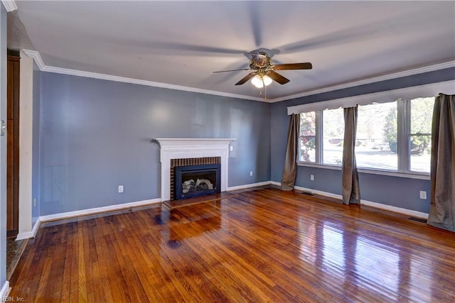 unfurnished living room featuring baseboards, a brick fireplace, crown molding, and hardwood / wood-style flooring