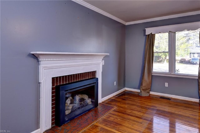 unfurnished living room featuring visible vents, baseboards, ornamental molding, a fireplace, and wood finished floors