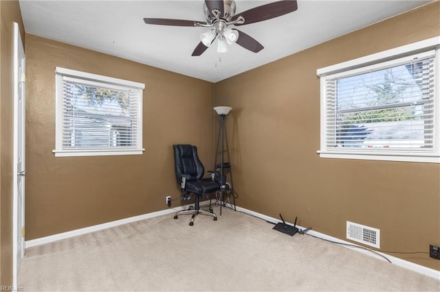 unfurnished room with visible vents, baseboards, a ceiling fan, and carpet flooring