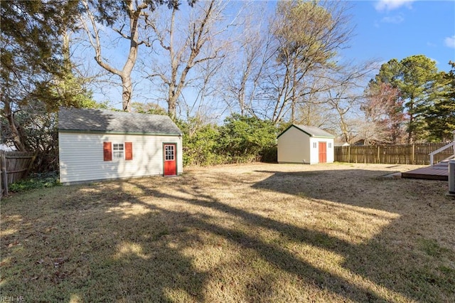 view of yard with an outdoor structure and a fenced backyard