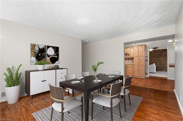 dining area with visible vents, a textured ceiling, dark wood-style floors, and a ceiling fan