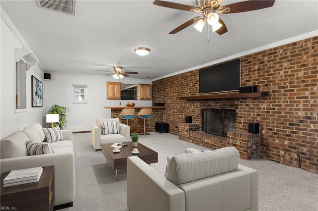 carpeted living room with visible vents, brick wall, ceiling fan, and ornamental molding