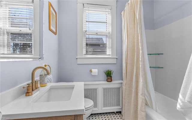 bathroom featuring plenty of natural light, shower / bath combination with curtain, toilet, and vanity