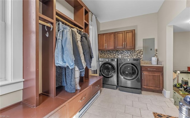 washroom featuring separate washer and dryer, electric panel, cabinet space, and light tile patterned flooring