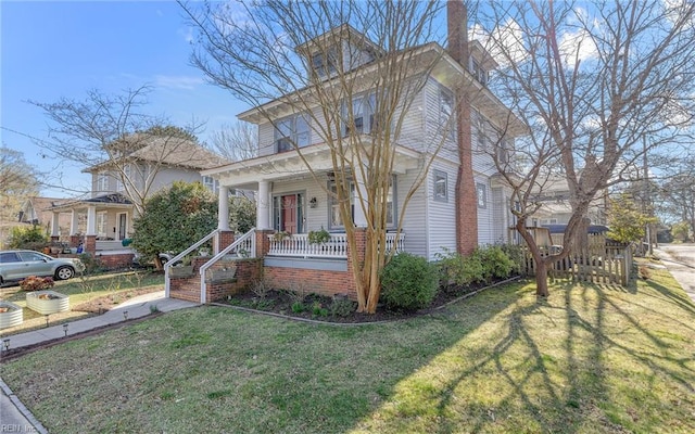 traditional style home with a porch and a front lawn