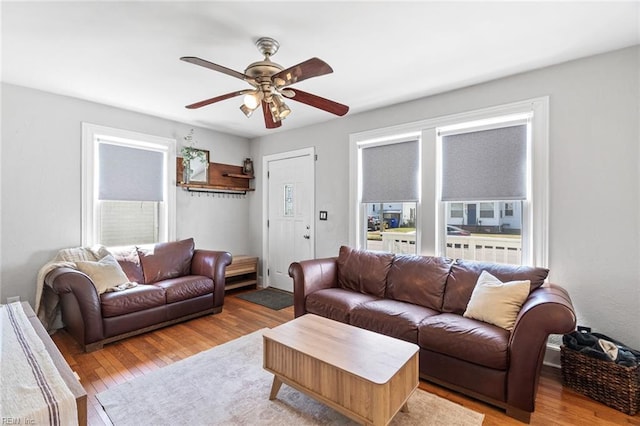 living room with ceiling fan, a healthy amount of sunlight, and wood finished floors