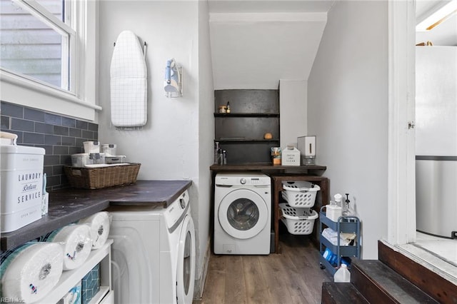 washroom featuring laundry area, washing machine and dryer, and wood finished floors