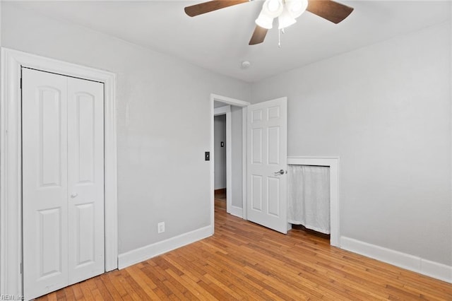 unfurnished bedroom with a ceiling fan, baseboards, and light wood-type flooring