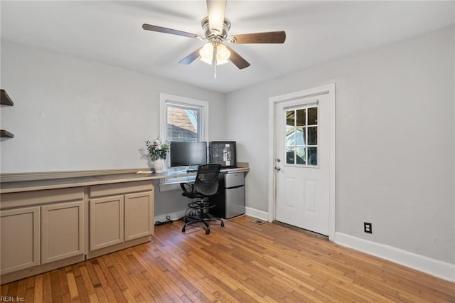 office area with a ceiling fan, baseboards, and light wood finished floors