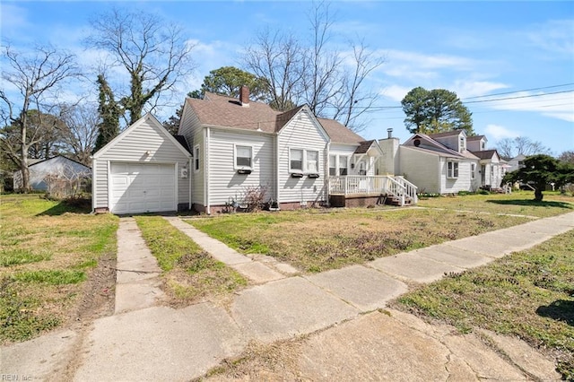 bungalow with a detached garage, a front yard, a chimney, an outdoor structure, and driveway