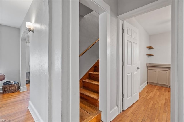 staircase with wood finished floors and baseboards