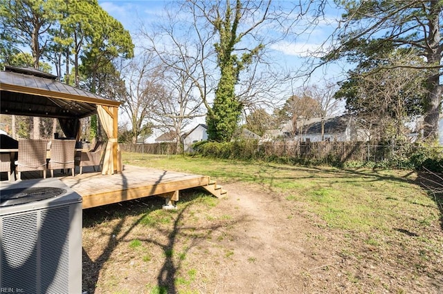 view of yard featuring a gazebo, a deck, and a fenced backyard