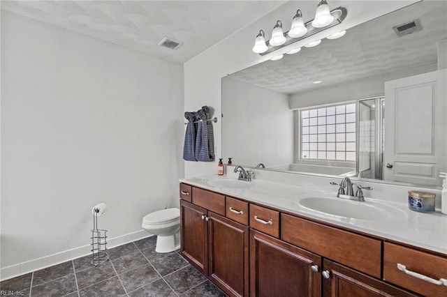 bathroom featuring double vanity, visible vents, and a sink