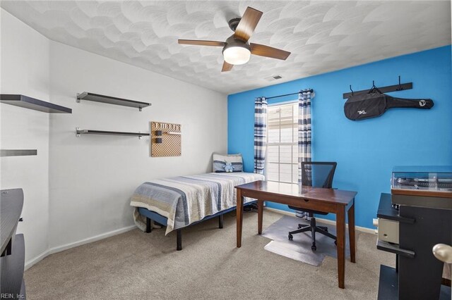 bedroom featuring ceiling fan, carpet, baseboards, and a textured ceiling