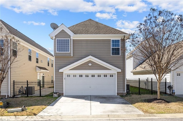 traditional home featuring cooling unit, an attached garage, driveway, and fence