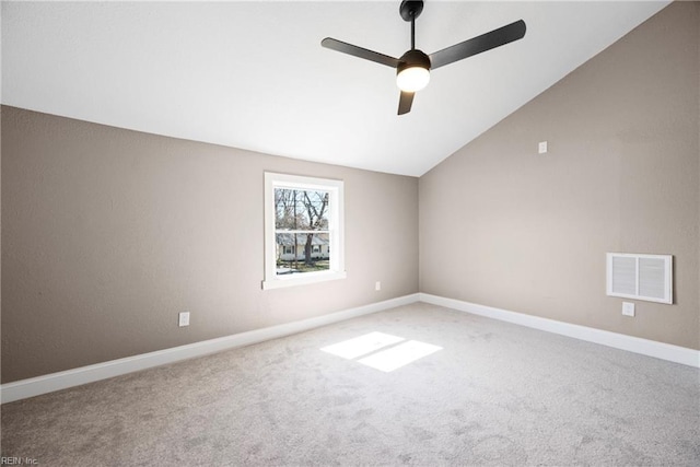 carpeted spare room with a ceiling fan, lofted ceiling, baseboards, and visible vents