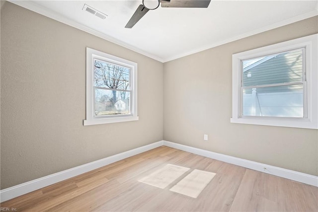 empty room with wood finished floors, baseboards, visible vents, and ceiling fan