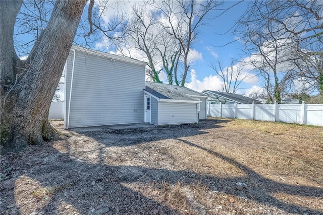 view of side of home featuring fence