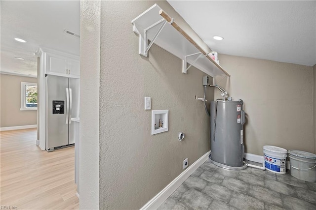 laundry area featuring laundry area, hookup for a washing machine, electric water heater, and baseboards