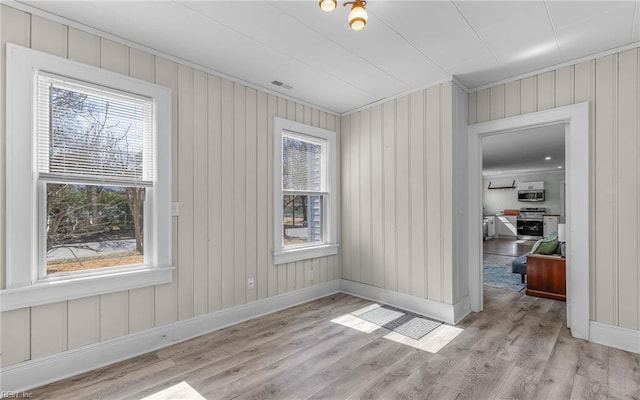 dining area featuring light wood-style flooring and baseboards