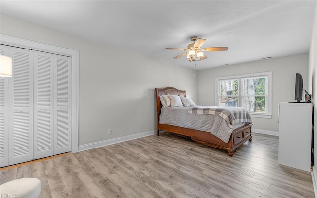 bedroom featuring a closet, ceiling fan, baseboards, and wood finished floors