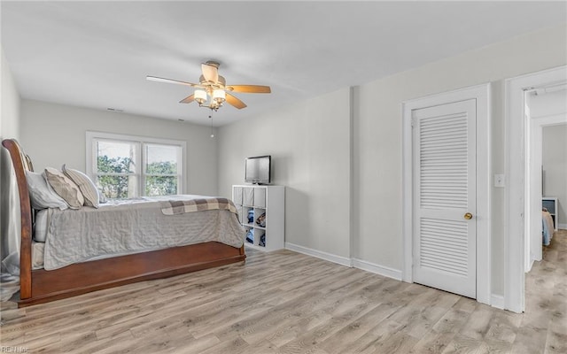 bedroom with visible vents, ceiling fan, baseboards, and wood finished floors