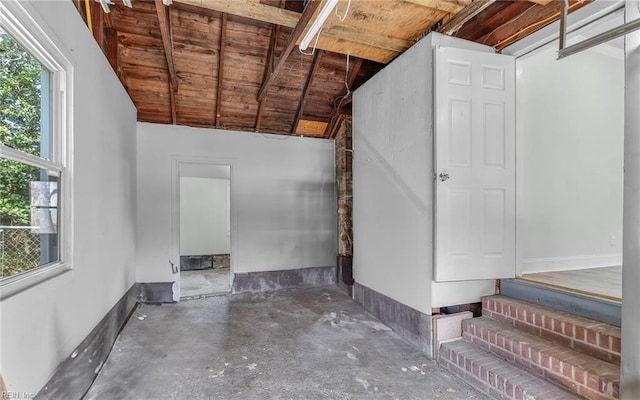 interior space featuring baseboards and wood ceiling