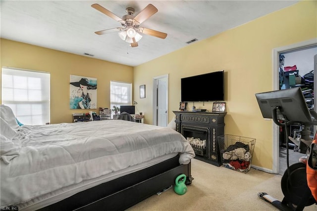 bedroom featuring visible vents, a ceiling fan, and carpet floors