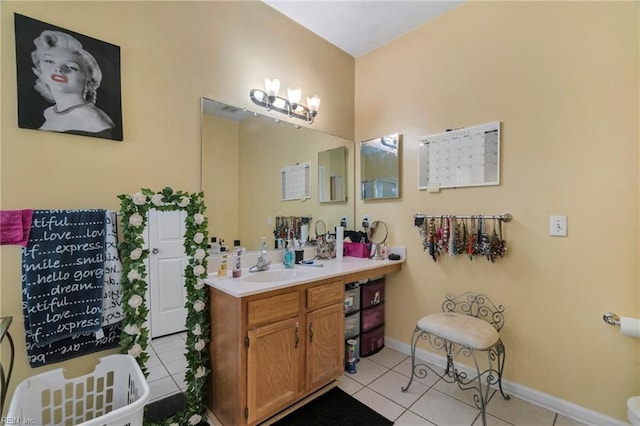 bathroom with vanity, tile patterned floors, and baseboards