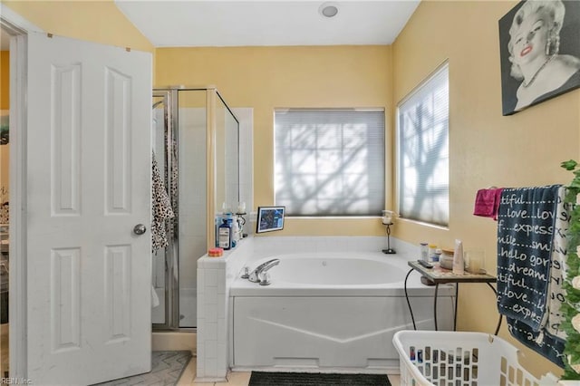 bathroom featuring a garden tub and a stall shower