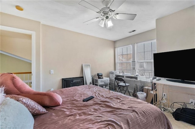 bedroom featuring visible vents, ceiling fan, and carpet flooring