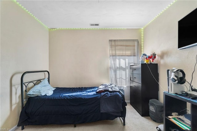 bedroom with visible vents and carpet