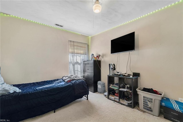 carpeted bedroom featuring visible vents