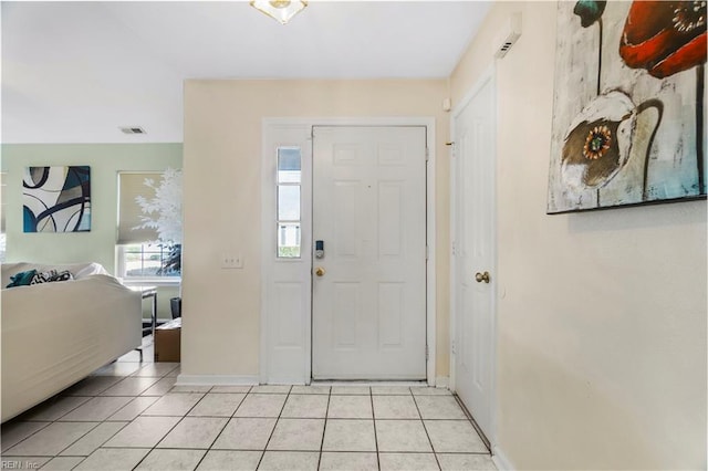 foyer entrance with light tile patterned floors, baseboards, and visible vents