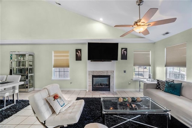 living room featuring light tile patterned floors, a fireplace, and a wealth of natural light