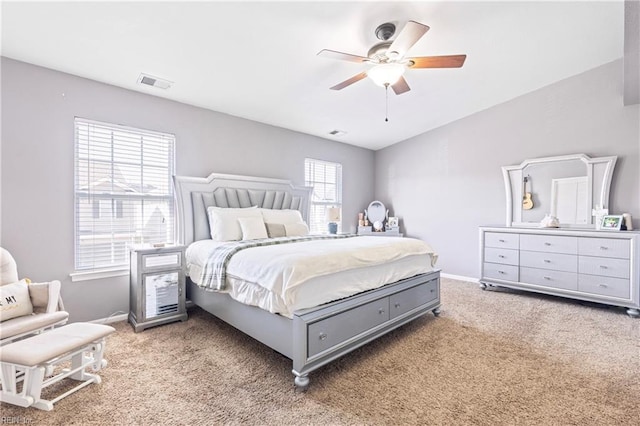 bedroom with visible vents, light colored carpet, a ceiling fan, and baseboards