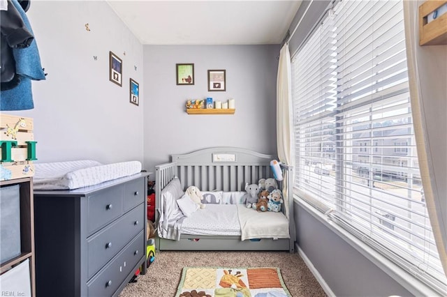 carpeted bedroom with baseboards