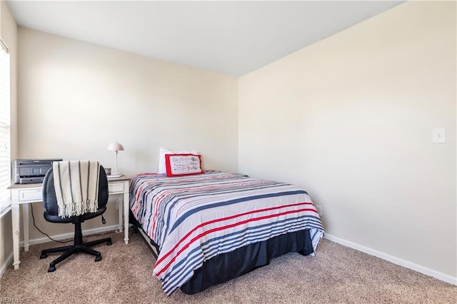 bedroom with baseboards and carpet