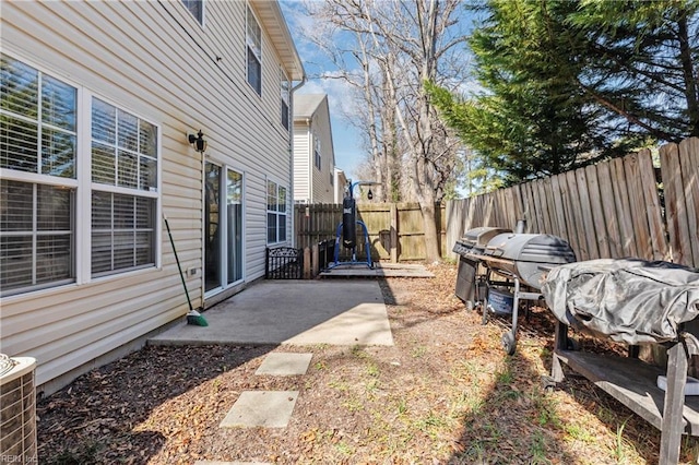 view of yard featuring a patio area, central AC unit, and a fenced backyard