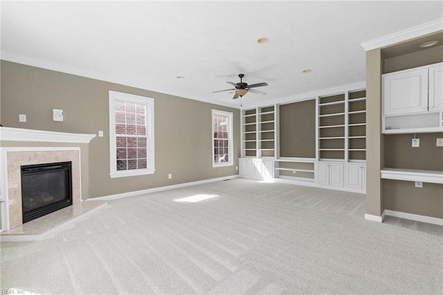 unfurnished living room featuring light carpet, crown molding, and a ceiling fan