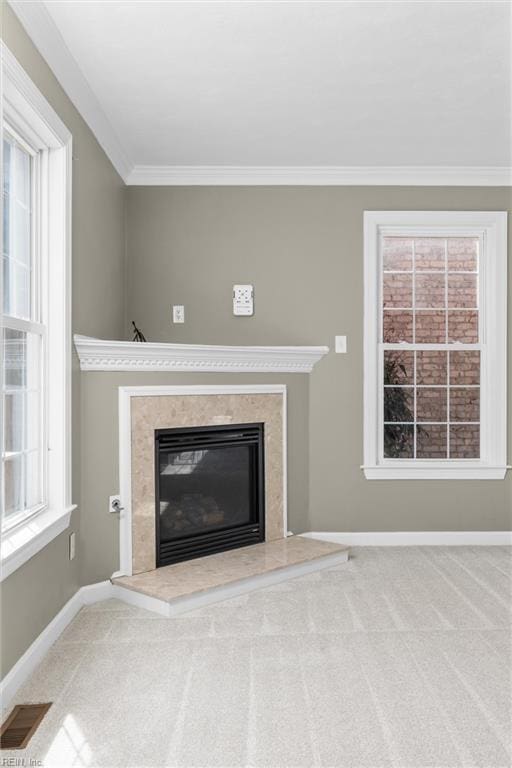 unfurnished living room with visible vents, baseboards, carpet, and a premium fireplace