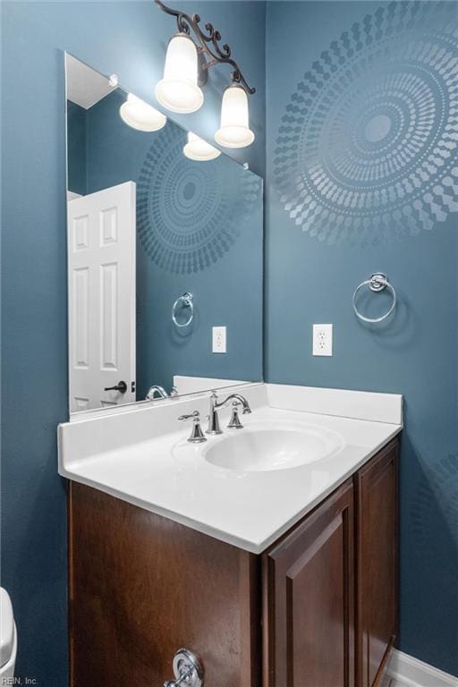 bathroom with vanity and baseboards