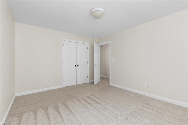 carpeted empty room featuring baseboards