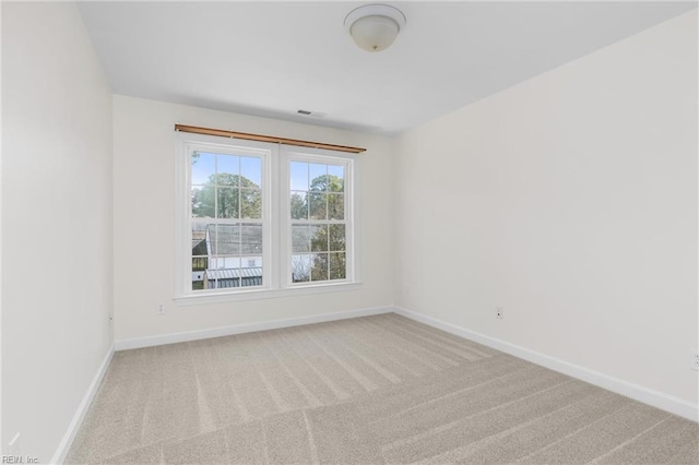 carpeted empty room with baseboards