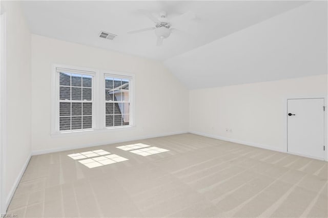 bonus room with visible vents, baseboards, ceiling fan, vaulted ceiling, and light carpet