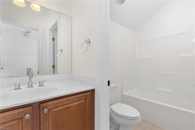 bathroom with tile patterned flooring, toilet, vaulted ceiling, shower / bathing tub combination, and vanity