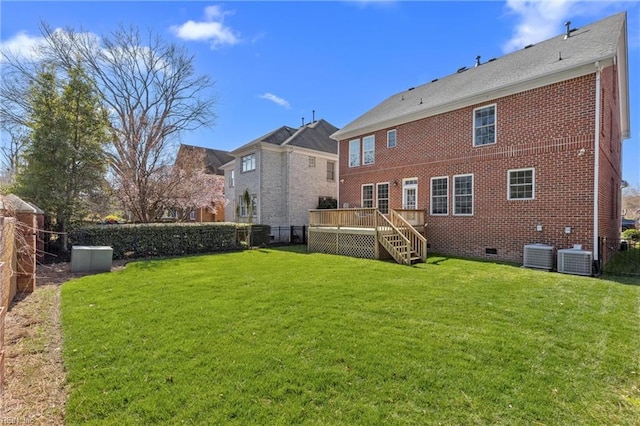 back of property with a lawn, a fenced backyard, a wooden deck, crawl space, and brick siding